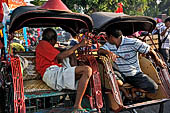 Riding the becak, the local cycle rickshaws in Malioboro street Yogyakarta. 